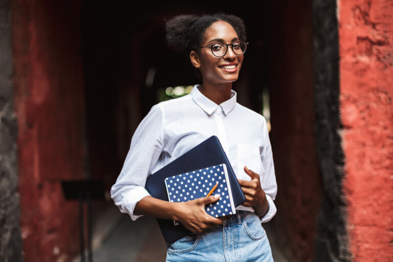 nice african girl in eyeglasses and shirt holding NMCWFYX scaled